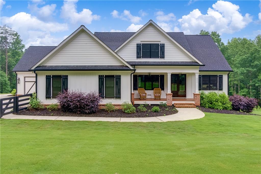 111 Nathans Ridge Ball Ground, GA 30107 - Photo 1 of 1 a front view of a house with swimming pool and porch