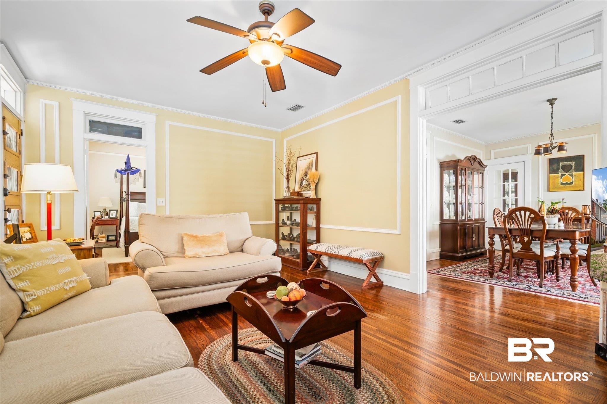 24 Macy Place Mobile, AL 36604 - Photo 9 of 38 Living area with crown molding, a ceiling fan, dark wood-style flooring, and baseboards