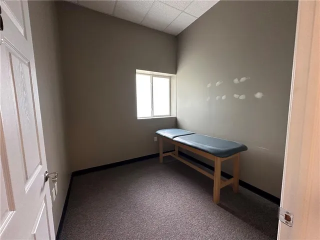 a room with pool table and windows