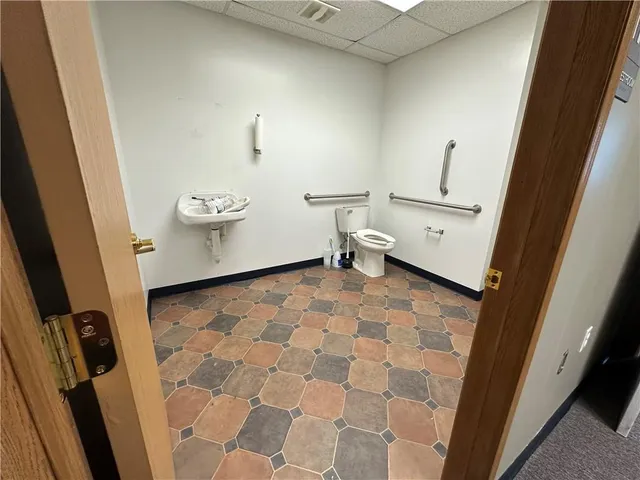 a bathroom with a sink a toilet and a mirror