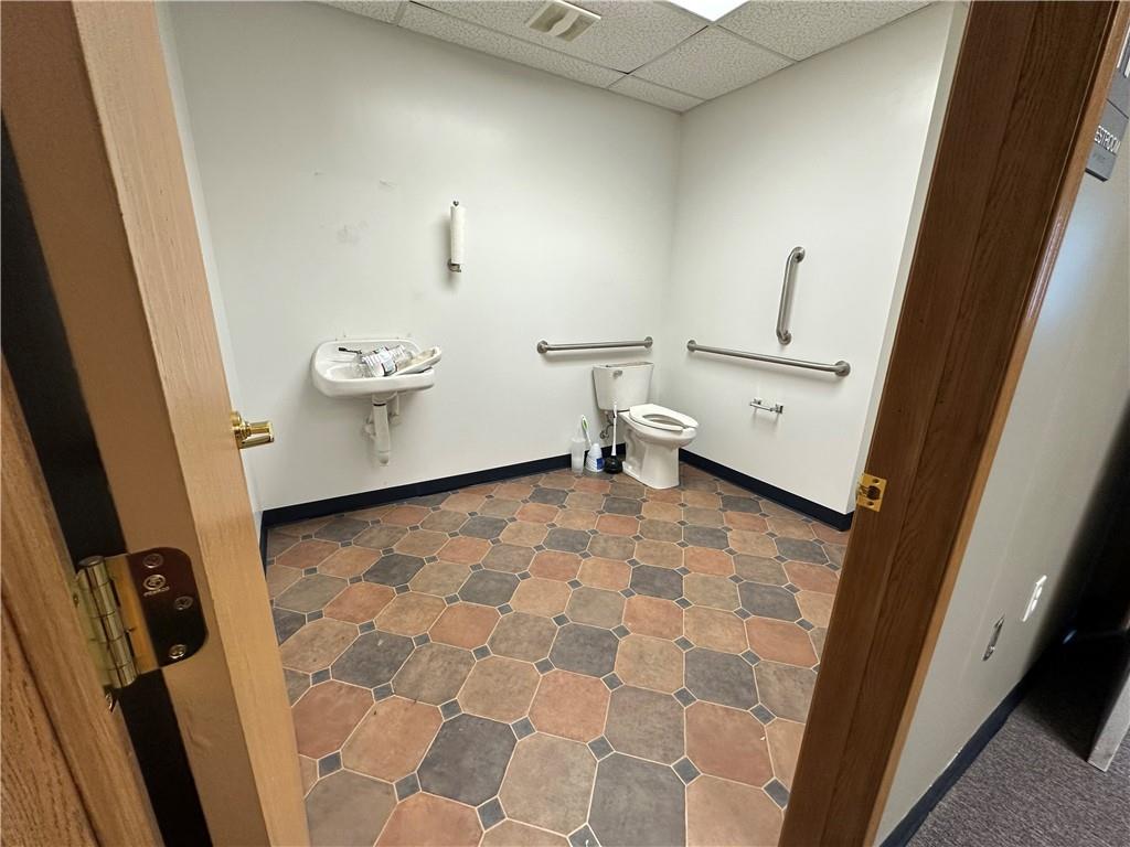 3379 Pittsburgh Street, Unit 109 Perryopolis, PA 15473 - Photo 17 of 30 a bathroom with a sink a toilet and a mirror