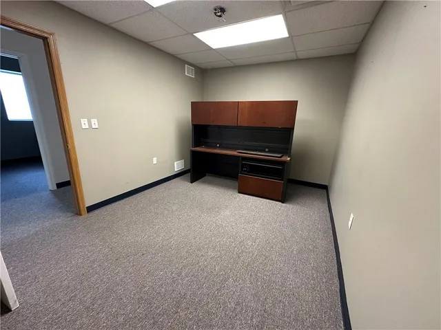 a room with furniture and air conditioner vent