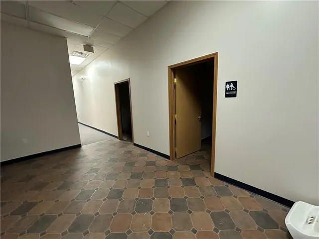 an empty room with wooden floor and closet