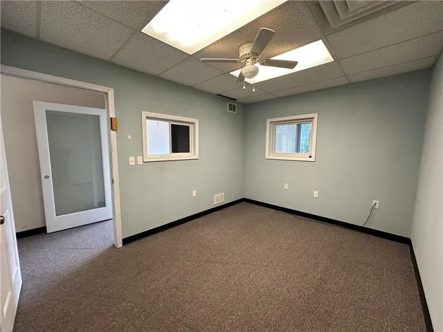 a view of a livingroom with a ceiling fan and window