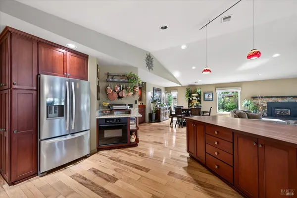 a kitchen with stainless steel appliances granite countertop a refrigerator and a sink