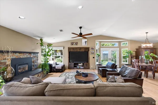 a living room with furniture fireplace and a large window