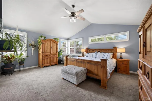 a spacious bedroom with a bed and a chandelier