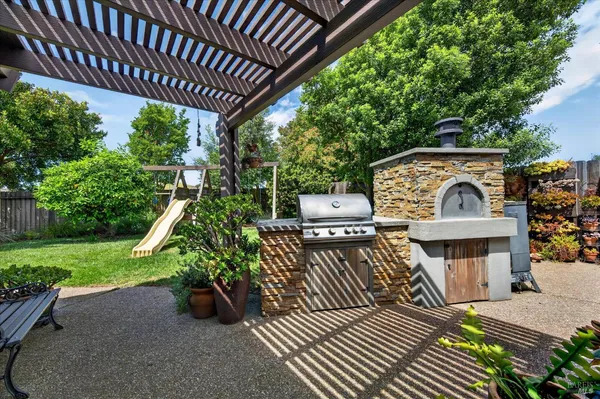 a view of a couches in patio of back yard