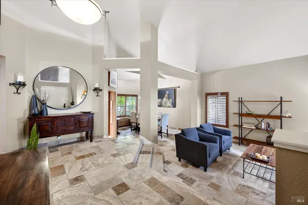 a living room with furniture a mirror and a fireplace