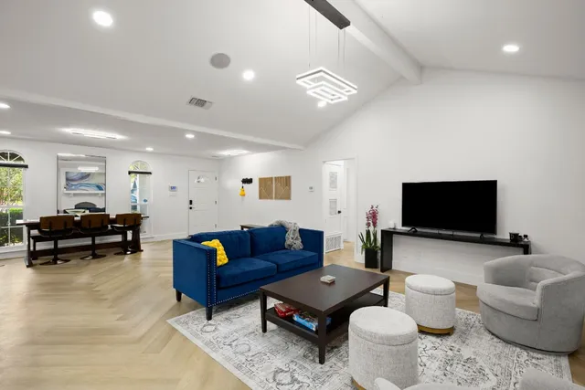 a living room with furniture a rug and a chandelier