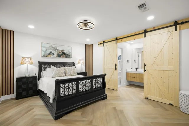 a kitchen that has a lot of white cabinets and stainless steel appliances