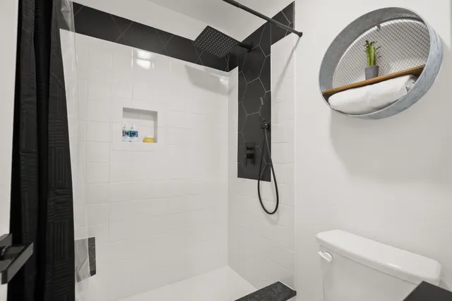 a bathroom with a double vanity sink mirror and toilet