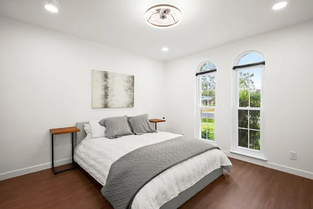 a bathroom with a granite countertop sink a mirror and a toilet