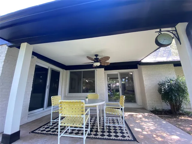 a view of a chairs and table in a patio
