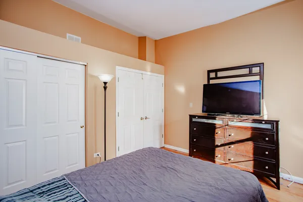 a room with a bed and television