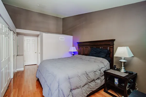 a bedroom with a bed and a lamp