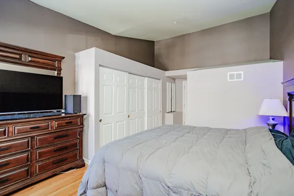 a bedroom with a bed and a flat screen tv