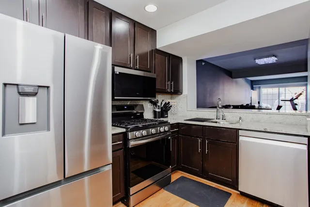 a kitchen with stainless steel appliances a refrigerator stove and sink