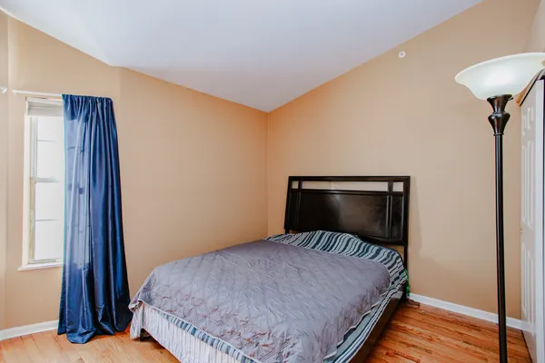 a bedroom with a bed and a lamp on table