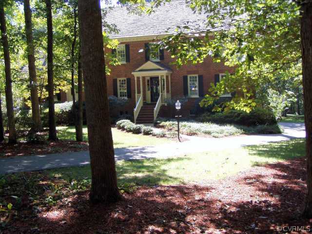 a front view of a house with a yard and mountain view