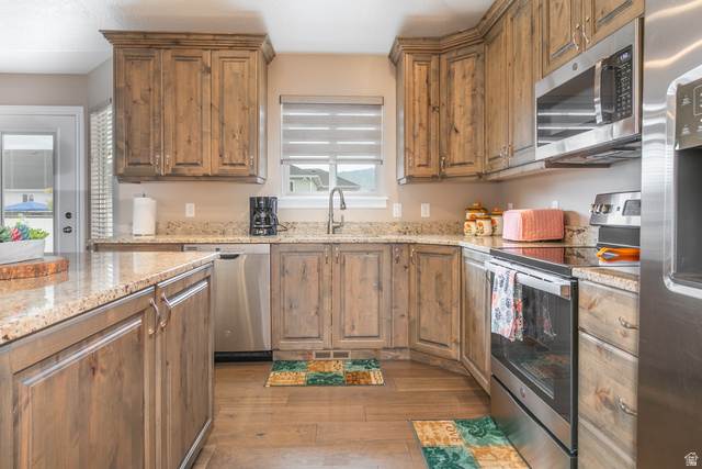 1228 North Providence Way Tooele, UT 84074 - Photo 11 of 28 Kitchen with granite countertops and wood-finish flooring