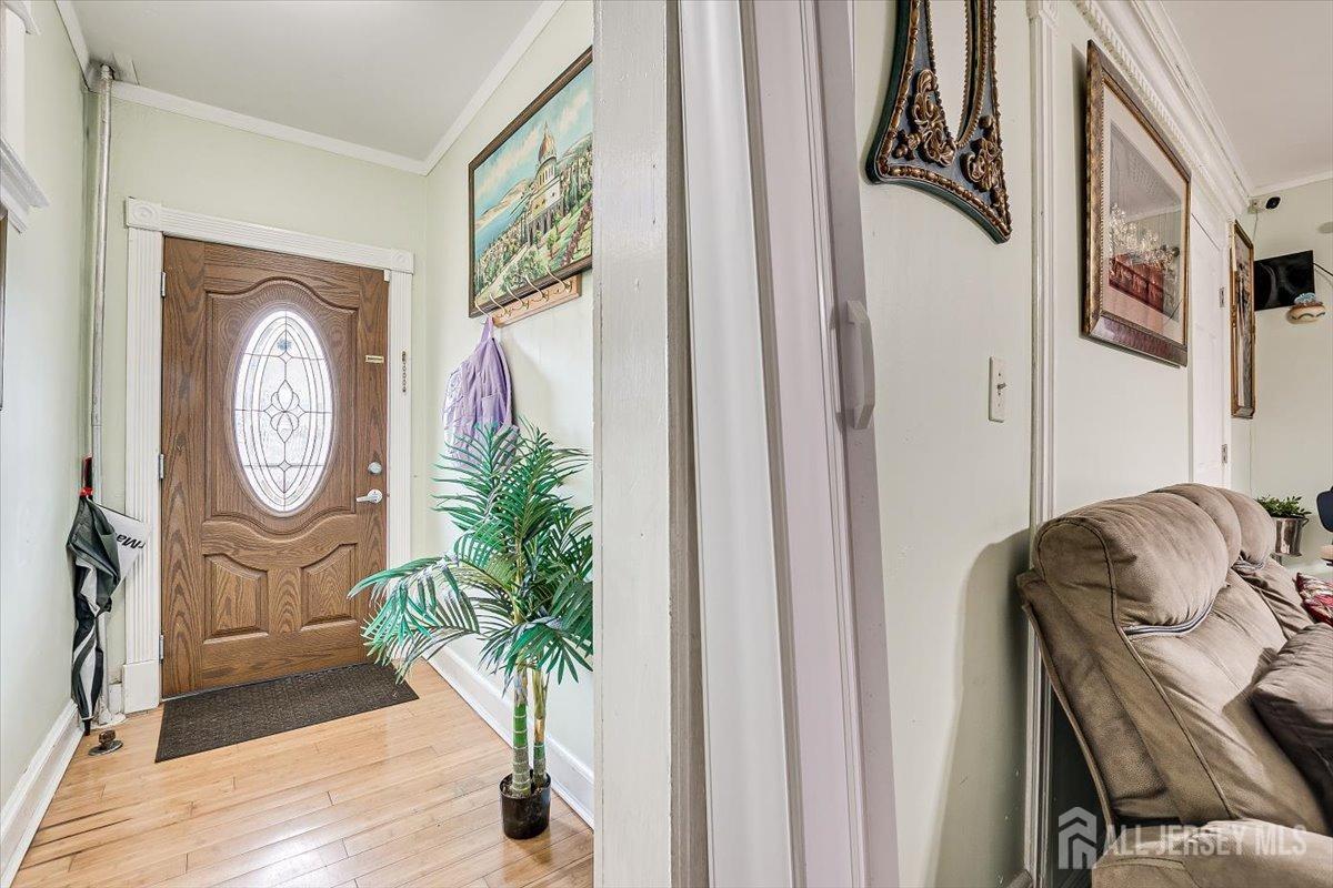 438 Lawrie Street Perth Amboy, NJ 08861 - Photo 15 of 49 a living room with furniture and a potted plant