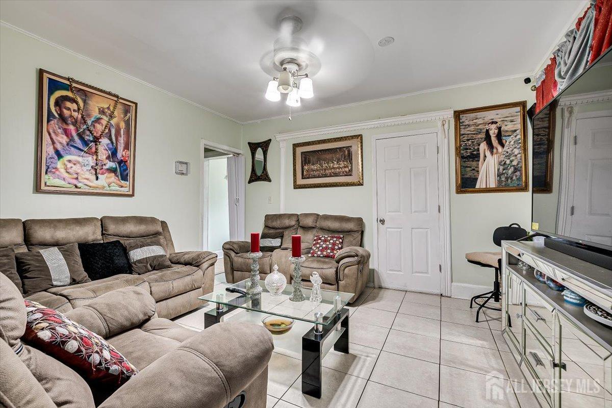 438 Lawrie Street Perth Amboy, NJ 08861 - Photo 16 of 49 a living room with furniture and a chandelier