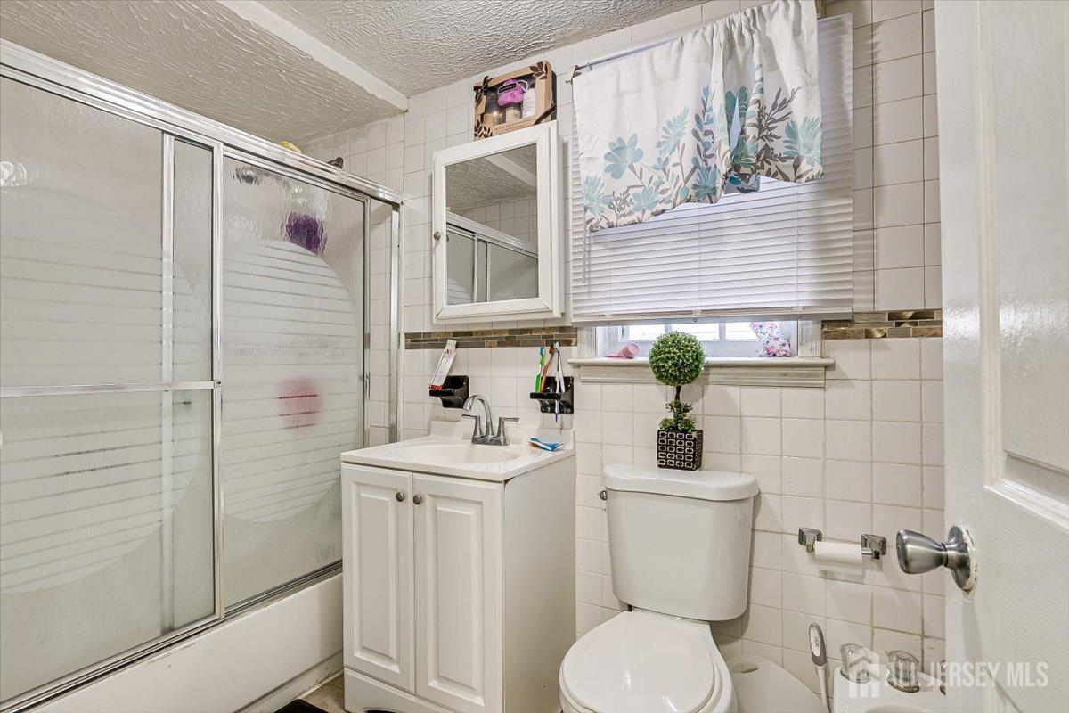 438 Lawrie Street Perth Amboy, NJ 08861 - Photo 24 of 49 a bathroom with a sink a toilet and shower
