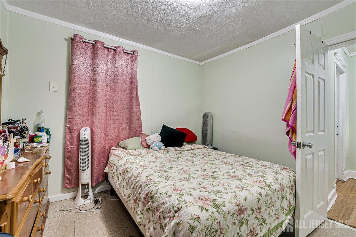 438 Lawrie Street Perth Amboy, NJ 08861 - Photo 26 of 49 a bedroom with a bed and a window