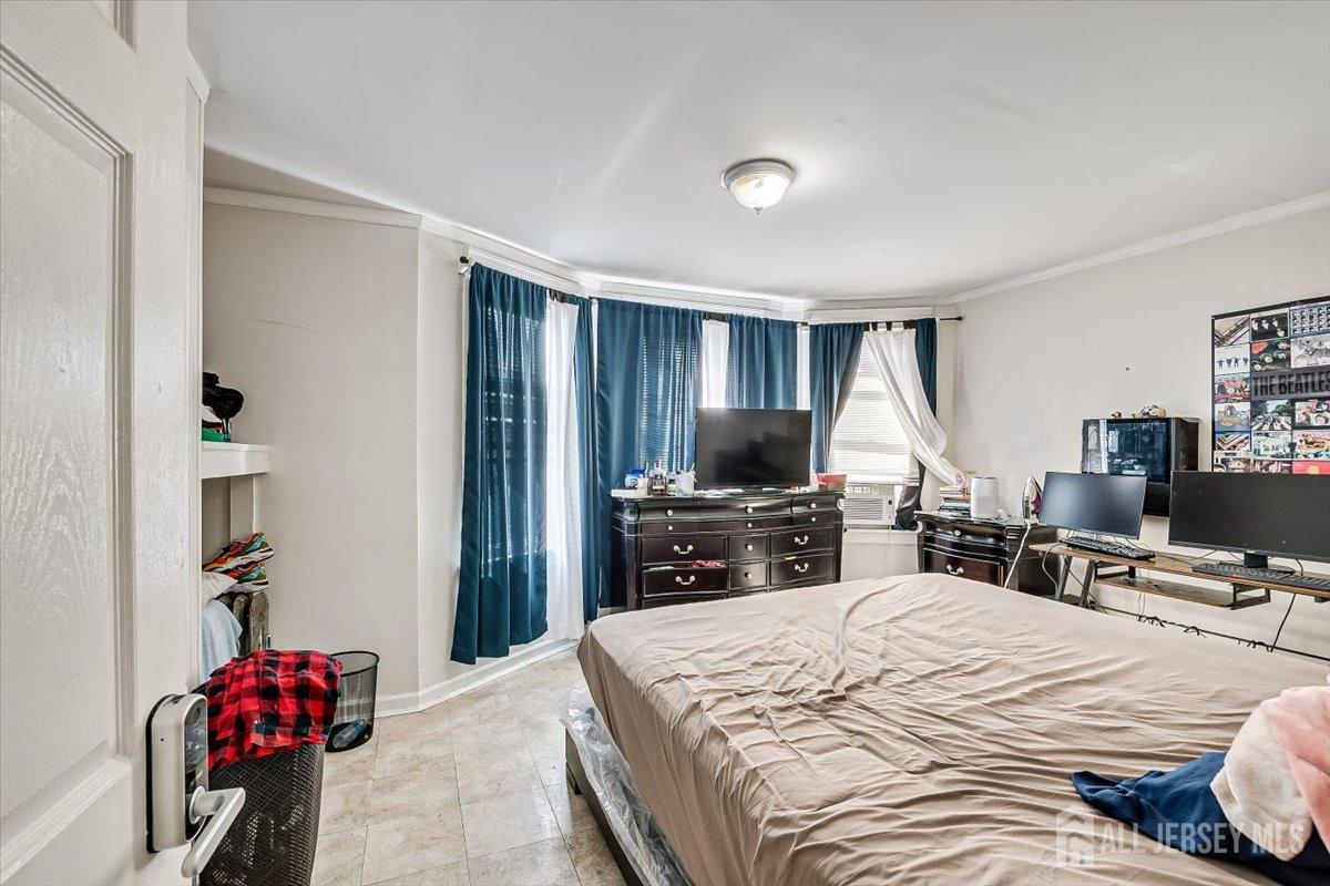 438 Lawrie Street Perth Amboy, NJ 08861 - Photo 28 of 49 a bedroom with a bed and a flat screen tv