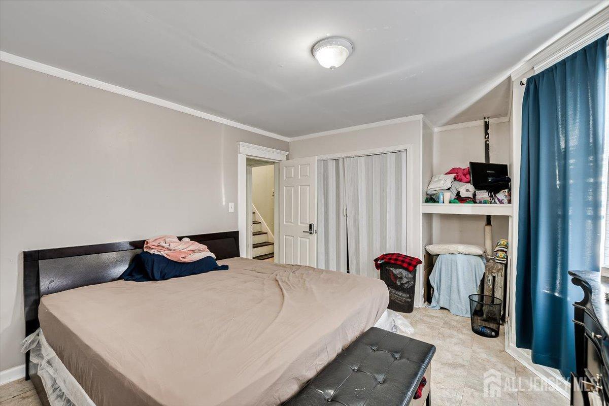 438 Lawrie Street Perth Amboy, NJ 08861 - Photo 29 of 49 a bedroom with a bed and closet