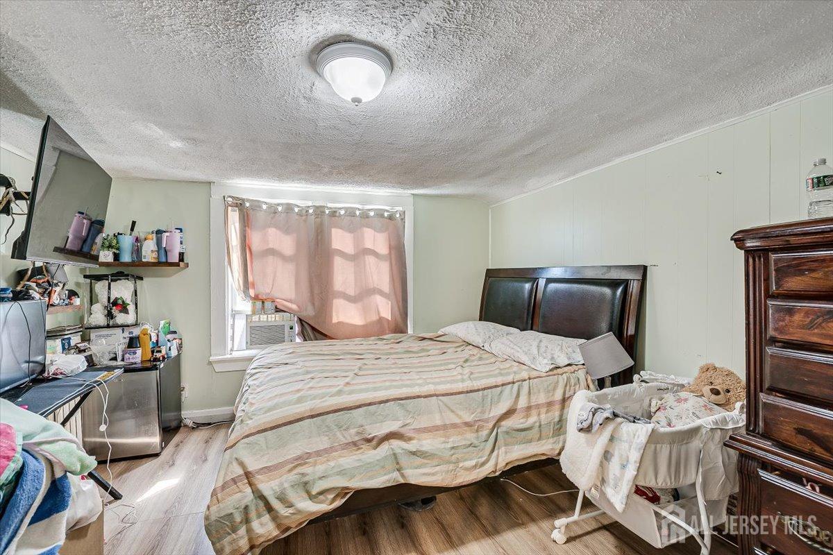 438 Lawrie Street Perth Amboy, NJ 08861 - Photo 31 of 49 a bedroom with a bed and wooden floor