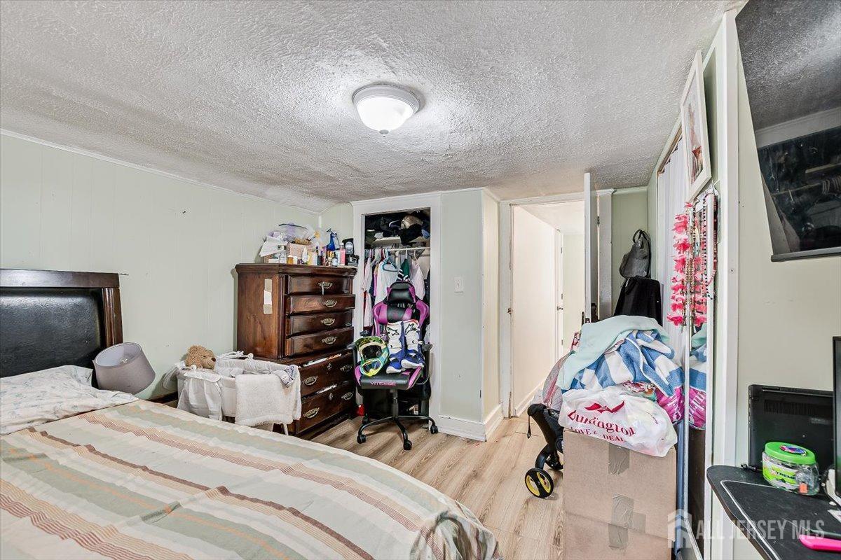 438 Lawrie Street Perth Amboy, NJ 08861 - Photo 32 of 49 a bedroom with a bed and a tv