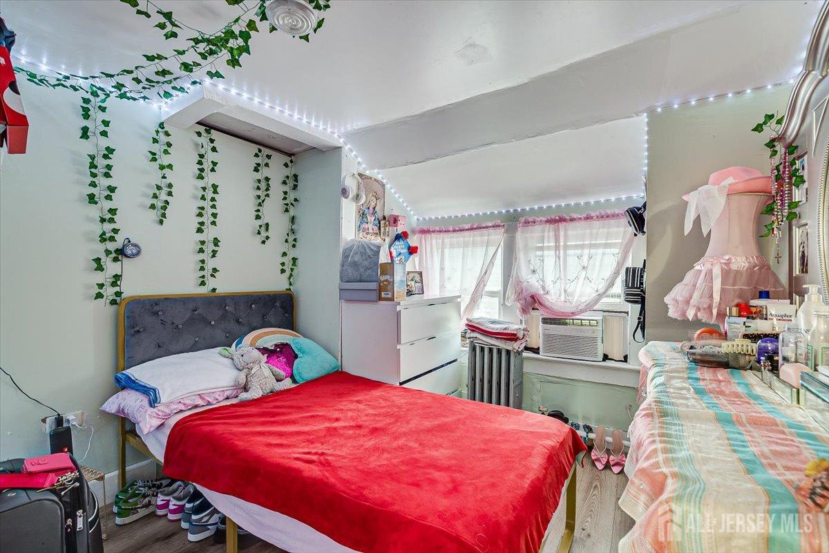 438 Lawrie Street Perth Amboy, NJ 08861 - Photo 33 of 49 a bed room with a bed and a baby