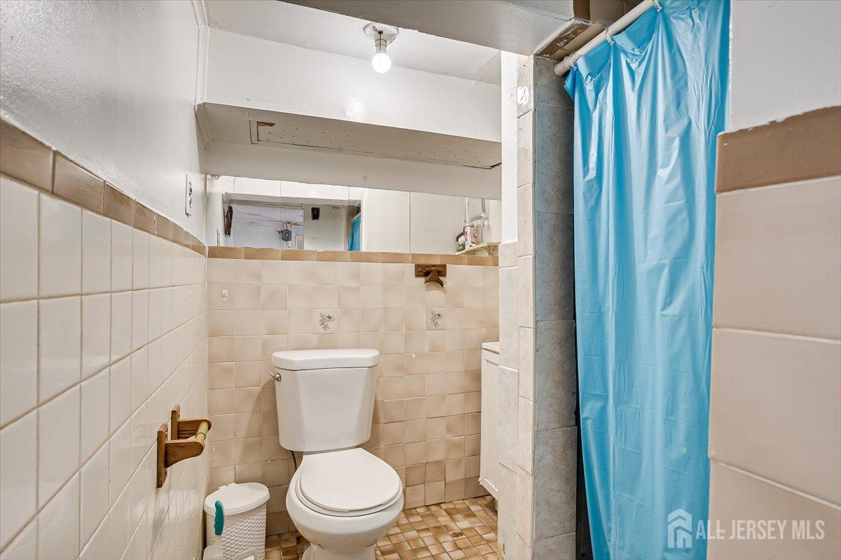 438 Lawrie Street Perth Amboy, NJ 08861 - Photo 35 of 49 a bathroom with a toilet and a shower