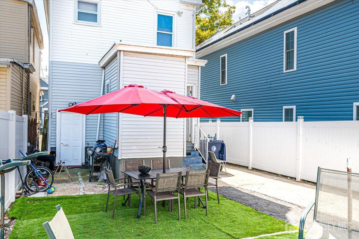 438 Lawrie Street Perth Amboy, NJ 08861 - Photo 38 of 49 a view of a house with a yard and sitting area