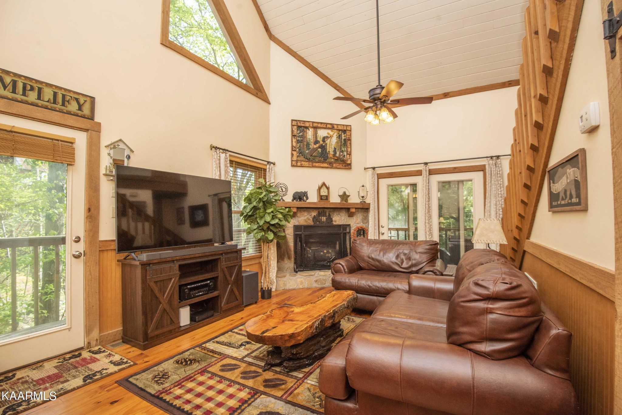 106 Club View Road Townsend, TN 37882 - Photo 2 of 55 a living room with furniture a flat screen tv and a floor to ceiling window