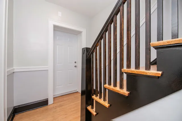 an empty room with a window and ceiling fan