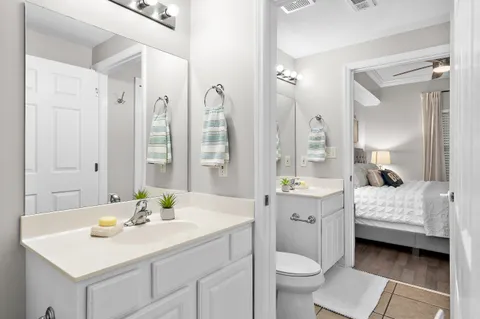 a en suite bathroom with a double vanity sink and a mirror