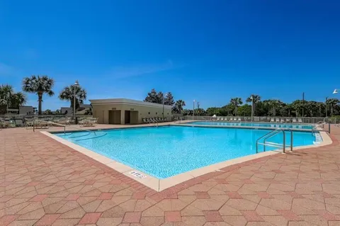 a view of a swimming pool and an outdoor seating