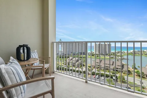 a view of a balcony with chairs and wooden floor