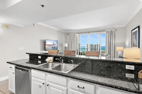 a kitchen with granite countertop a sink and a counter top space
