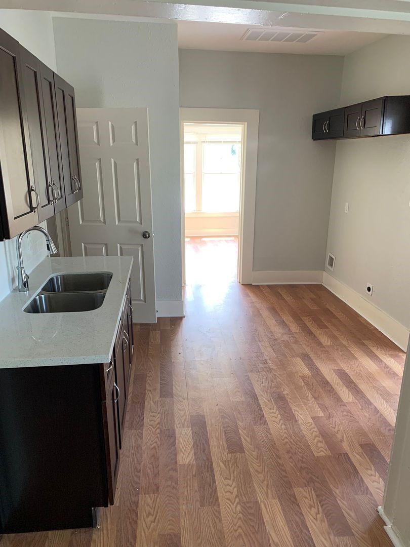 1294 Cartwright Street Beaumont, TX 77701 - Photo 2 of 6 a kitchen with kitchen island a sink appliances and cabinets