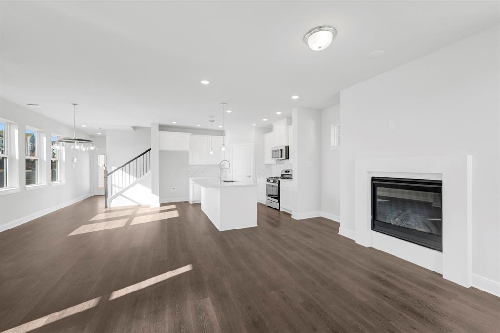 3501 Pineda Way McKinney, TX 75071 - Photo 13 of 40 a view of empty room with wooden floor and fireplace