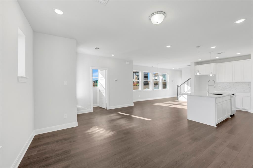 3501 Pineda Way McKinney, TX 75071 - Photo 14 of 40 an empty room with wooden floor and windows
