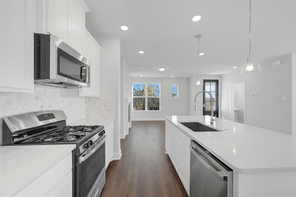 3501 Pineda Way McKinney, TX 75071 - Photo 17 of 40 a kitchen with stainless steel appliances sink stove microwave and cabinets
