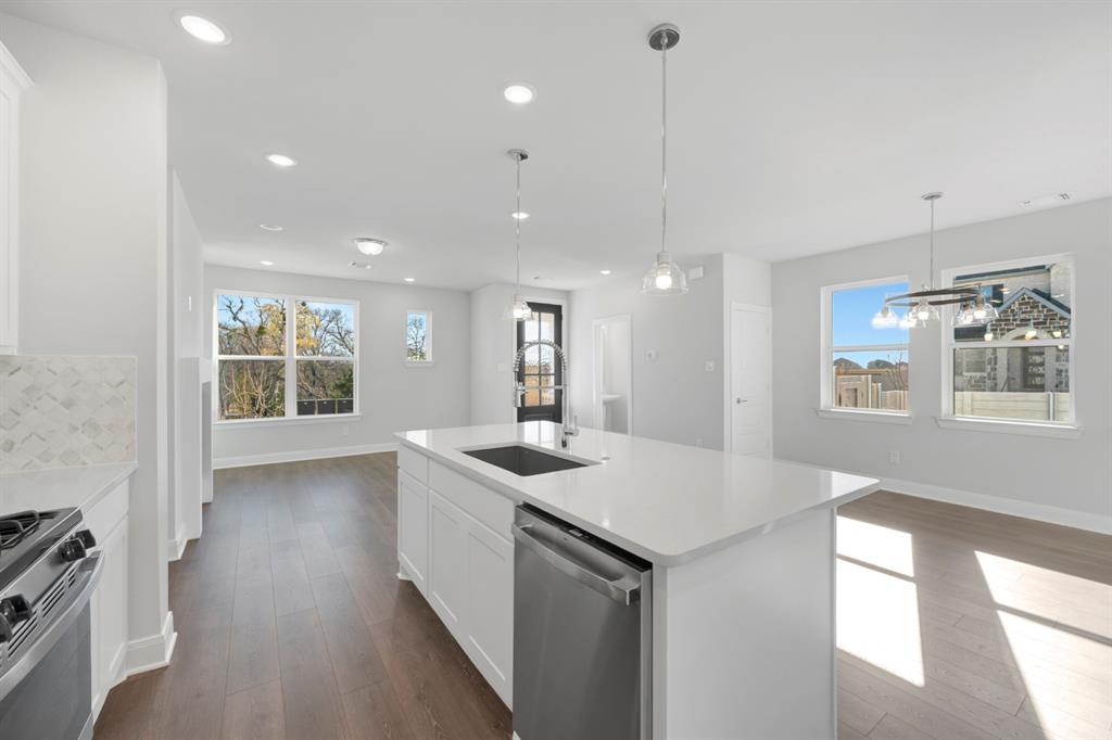 3501 Pineda Way McKinney, TX 75071 - Photo 21 of 40 a kitchen with a sink stove and wooden floor