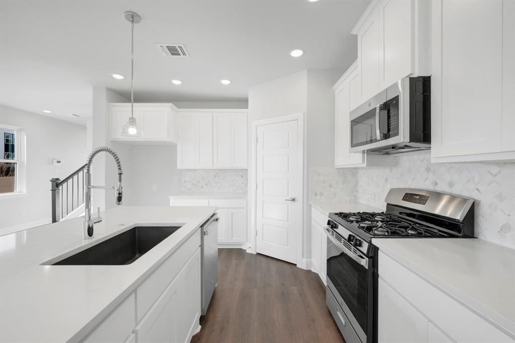 3501 Pineda Way McKinney, TX 75071 - Photo 22 of 40 a kitchen that has a sink and a stove top oven