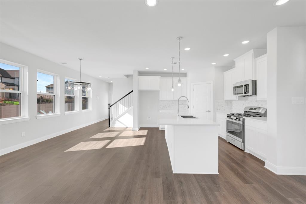 3501 Pineda Way McKinney, TX 75071 - Photo 24 of 40 a open kitchen with stainless steel appliances kitchen island a refrigerator and a stove top oven