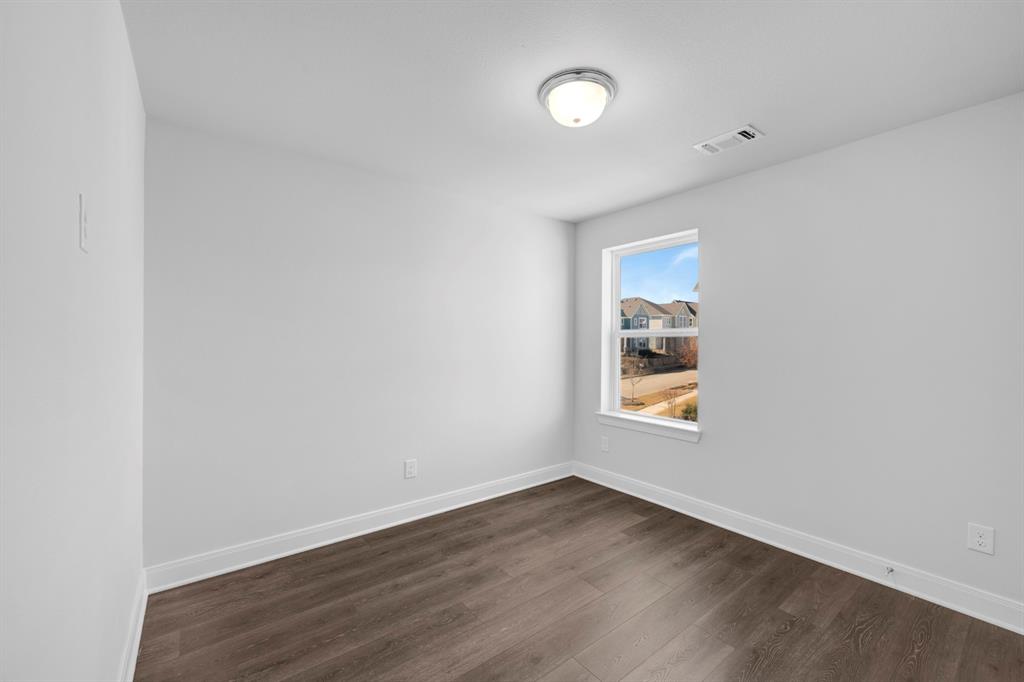 3501 Pineda Way McKinney, TX 75071 - Photo 30 of 40 an empty room with wooden floor and windows